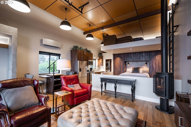 33723 Van Duyn Rd, Eugene, OR 97408 - bedroom with stainless steel refrigerator with ice dispenser, wood ceiling, a wall mounted AC, wood finished floors, and beam ceiling