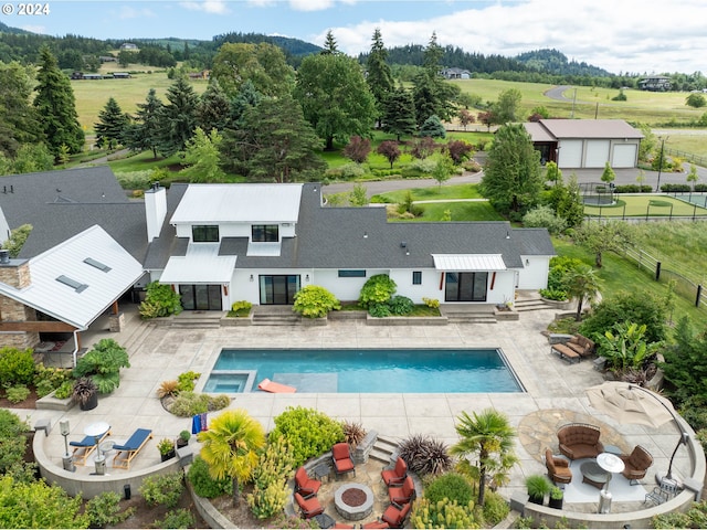 33723 Van Duyn Rd, Eugene, OR 97408 - view of swimming pool with a fire pit, fence, a patio, and a pool with connected hot tub