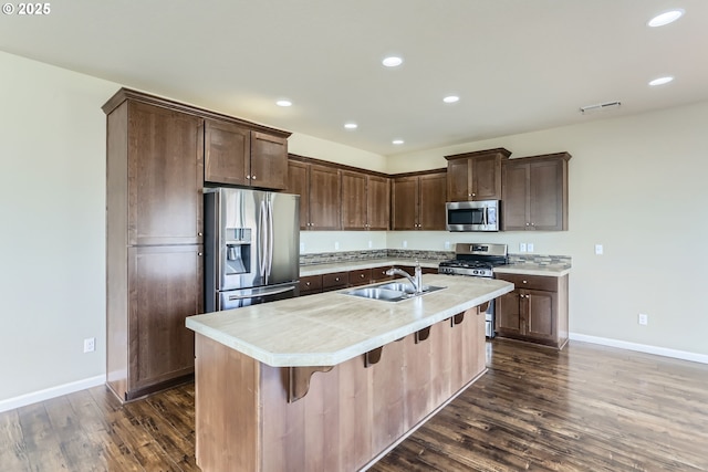 7359 NW 168th Ave, Portland, OR 97229 - kitchen with appliances with stainless steel finishes, dark wood-type flooring, light countertops, dark brown cabinetry, and recessed lighting