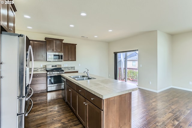 7359 NW 168th Ave, Portland, OR 97229 - kitchen with stainless steel appliances, dark wood-style floors, light countertops, recessed lighting, and an island with sink