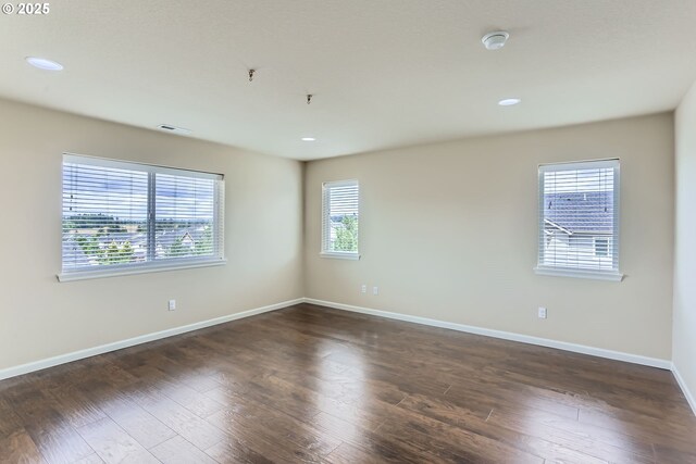 7359 NW 168th Ave, Portland, OR 97229 - empty room with healthy amount of natural light, wood finished floors, recessed lighting, and a smoke detector