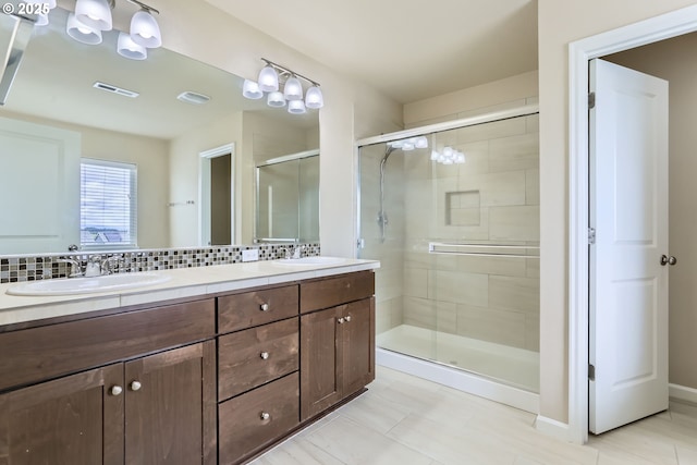 7359 NW 168th Ave, Portland, OR 97229 - bathroom with double vanity, a shower stall, decorative backsplash, and tile patterned flooring