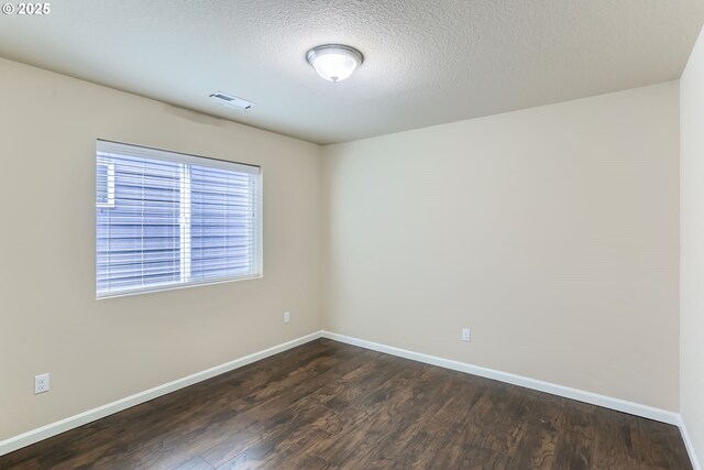 7359 NW 168th Ave, Portland, OR 97229 - spare room with dark wood-type flooring and a textured ceiling