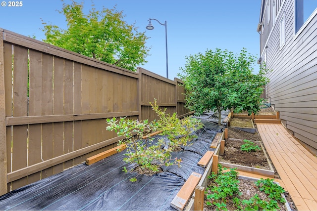7359 NW 168th Ave, Portland, OR 97229 - wooden deck with a vegetable garden