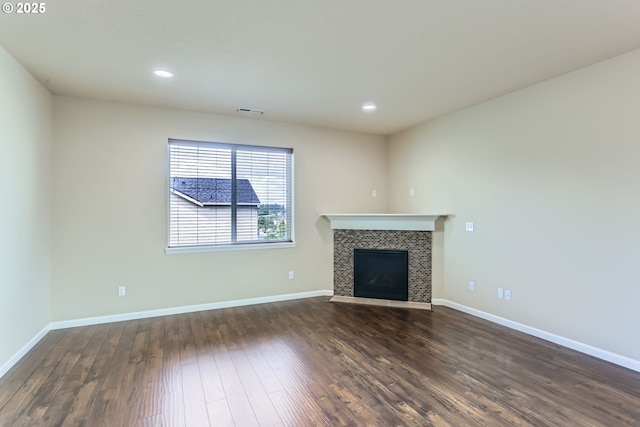 7359 NW 168th Ave, Portland, OR 97229 - unfurnished living room featuring dark wood finished floors, a tiled fireplace, and recessed lighting