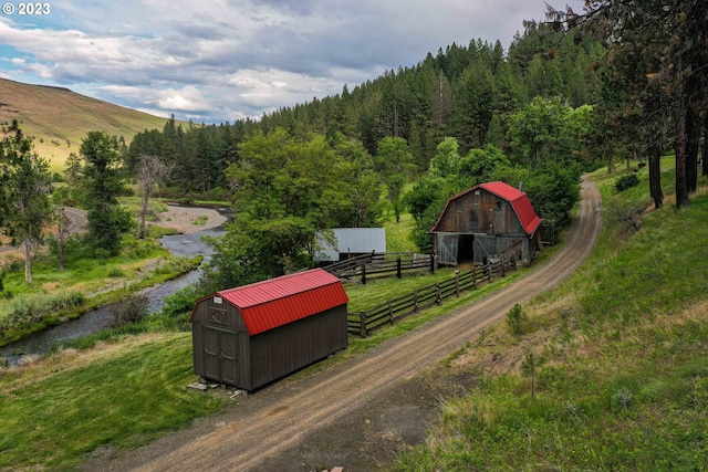 view of home's community featuring a rural view and a shed