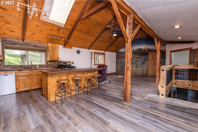 kitchen with stainless steel range, beam ceiling, a skylight, wooden ceiling, and dishwasher