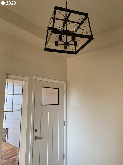 interior details featuring wood-type flooring and a chandelier