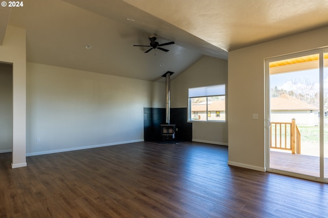 223 N Johnson St, Prairie City, OR 97869 - unfurnished living room with vaulted ceiling, ceiling fan, a wood stove, and dark wood finished floors