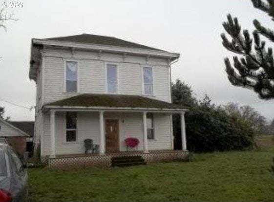 view of front of home with a front yard and a porch