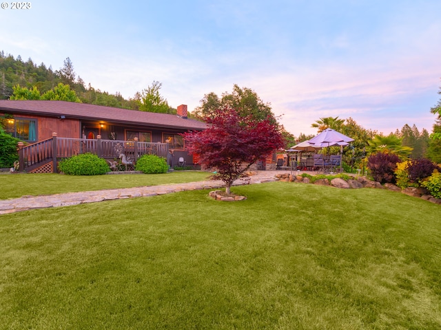 yard at dusk with a deck