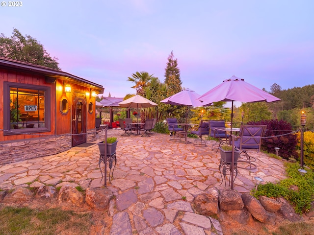 view of patio terrace at dusk