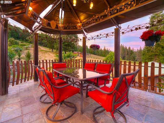 patio terrace at dusk featuring a gazebo