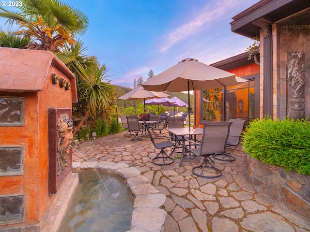 view of patio terrace at dusk