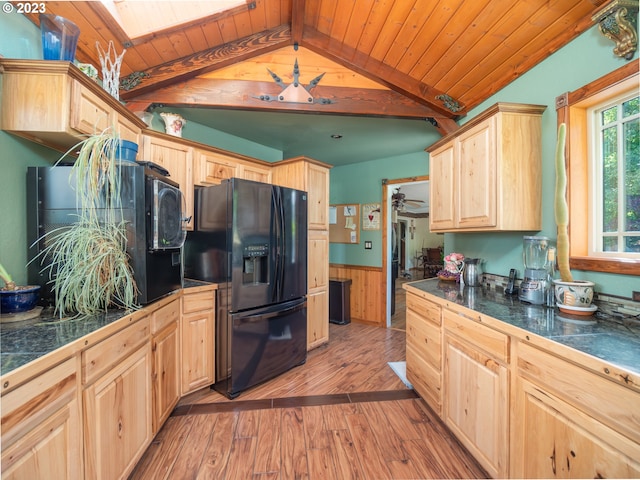 kitchen featuring wooden ceiling, black fridge, vaulted ceiling with beams, light brown cabinetry, and light wood-type flooring