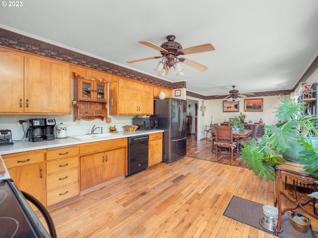 kitchen featuring black dishwasher, light hardwood / wood-style floors, stainless steel fridge, and ceiling fan