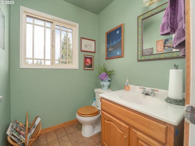 bathroom featuring toilet, tile flooring, and oversized vanity