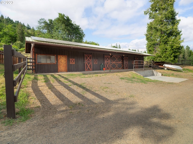 rear view of house with an outdoor structure