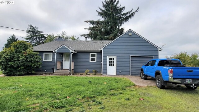 single story home featuring a front yard and a garage