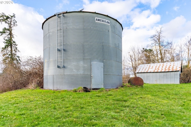 view of outbuilding featuring a lawn