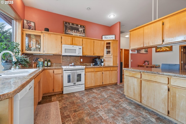 kitchen with light brown cabinetry, sink, backsplash, and white appliances