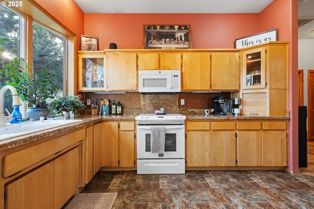 kitchen featuring sink, tasteful backsplash, and white appliances