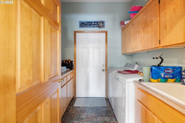 laundry area with cabinets, independent washer and dryer, and sink