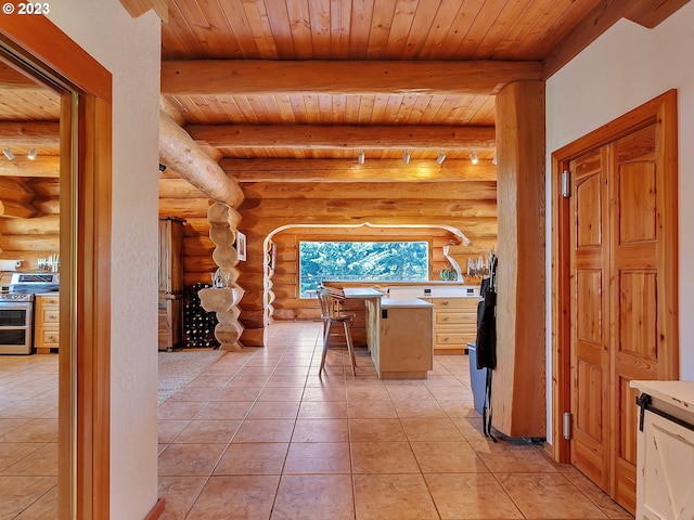 interior space with light tile flooring, log walls, and wooden ceiling