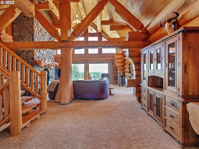 living room featuring high vaulted ceiling, log walls, light carpet, beam ceiling, and wooden ceiling