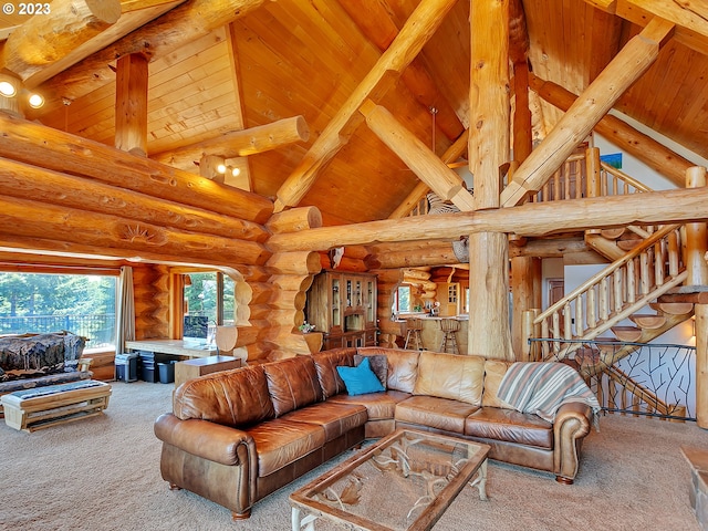 living room with beamed ceiling, high vaulted ceiling, log walls, light carpet, and wooden ceiling