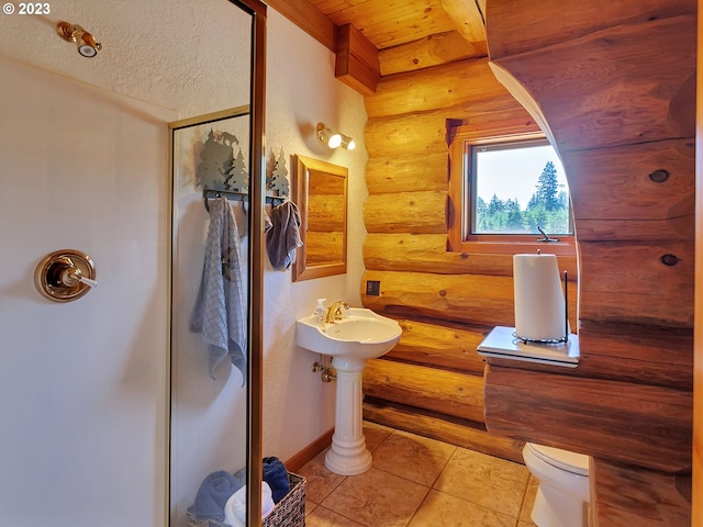 bathroom featuring toilet, rustic walls, tile floors, and wood ceiling