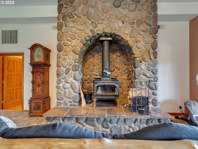 carpeted living room featuring a wood stove