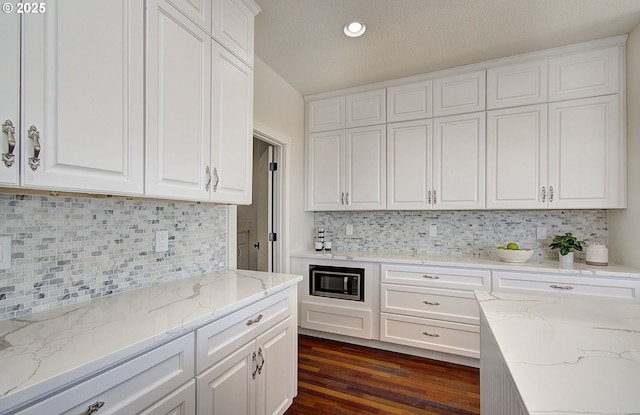 kitchen featuring white cabinets and decorative backsplash