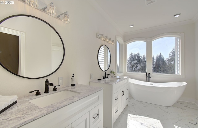 full bath with a freestanding bath, crown molding, and a sink