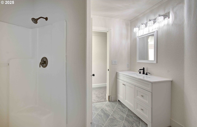 bathroom featuring vanity, marble finish floor, a shower, baseboards, and ornamental molding