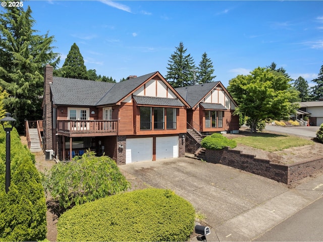 11185 SE Saint Lucy Ln, Happy Valley, OR 97086 - view of front facade with stairway, asphalt driveway, a garage, a chimney, and a wooden deck