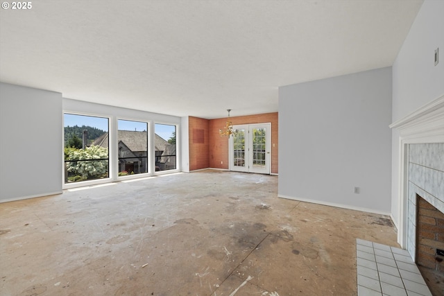 11185 SE Saint Lucy Ln, Happy Valley, OR 97086 - unfurnished living room featuring a tiled fireplace and a chandelier