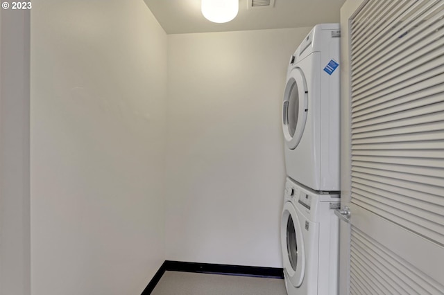 laundry area featuring stacked washer / drying machine