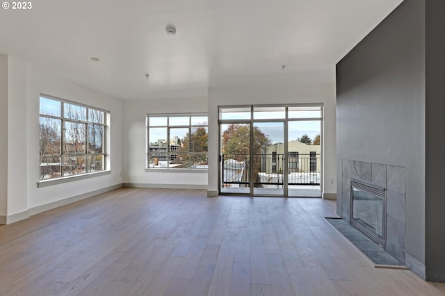 unfurnished living room with light wood-type flooring and a fireplace