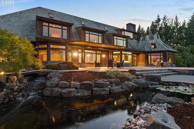 view of back house at dusk