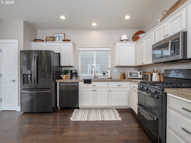 kitchen featuring sink, black appliances, dark hardwood / wood-style floors, and white cabinets