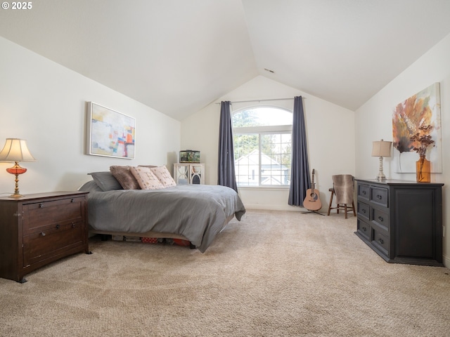 bedroom featuring vaulted ceiling and light carpet