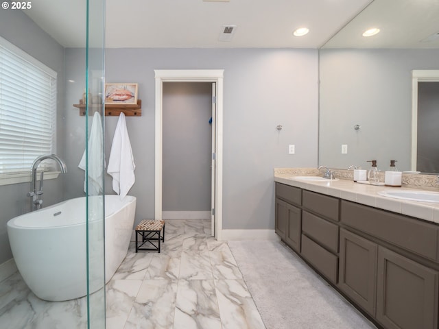 bathroom featuring vanity and a tub to relax in