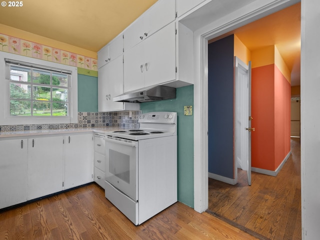 510 SE Shafford St, Estacada, OR 97023 - kitchen featuring white range with electric stovetop, light countertops, under cabinet range hood, white cabinetry, and wood finished floors