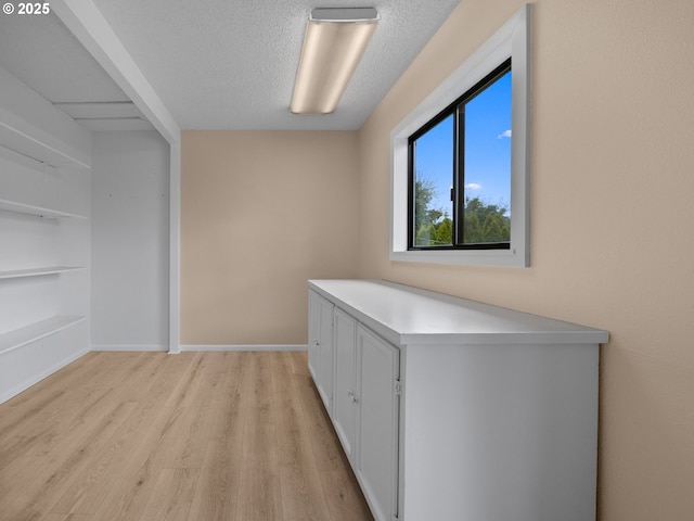 510 SE Shafford St, Estacada, OR 97023 - interior space with light wood-style flooring, a textured ceiling, and baseboards