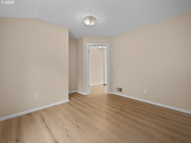 510 SE Shafford St, Estacada, OR 97023 - unfurnished room featuring light wood-style flooring, a textured ceiling, baseboards, and visible vents