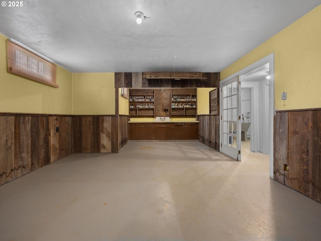 510 SE Shafford St, Estacada, OR 97023 - finished basement featuring wooden walls, a textured ceiling, and a wainscoted wall