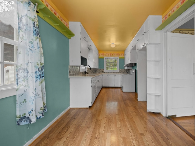 510 SE Shafford St, Estacada, OR 97023 - kitchen featuring a sink, white cabinets, light wood-type flooring, and stove