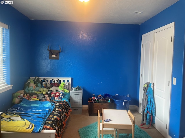 bedroom with carpet flooring and multiple windows