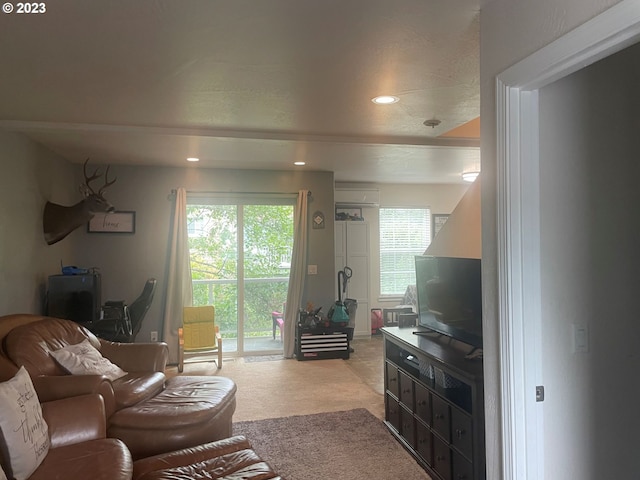 carpeted living room with a wall mounted AC